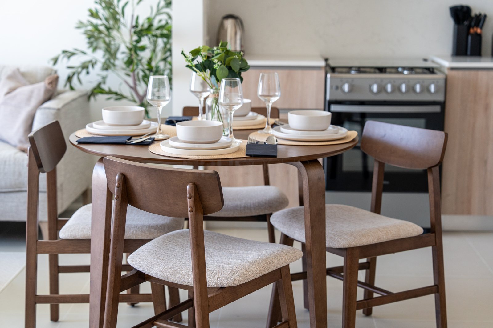 Dining table set with crockery, cutlery and glassware
