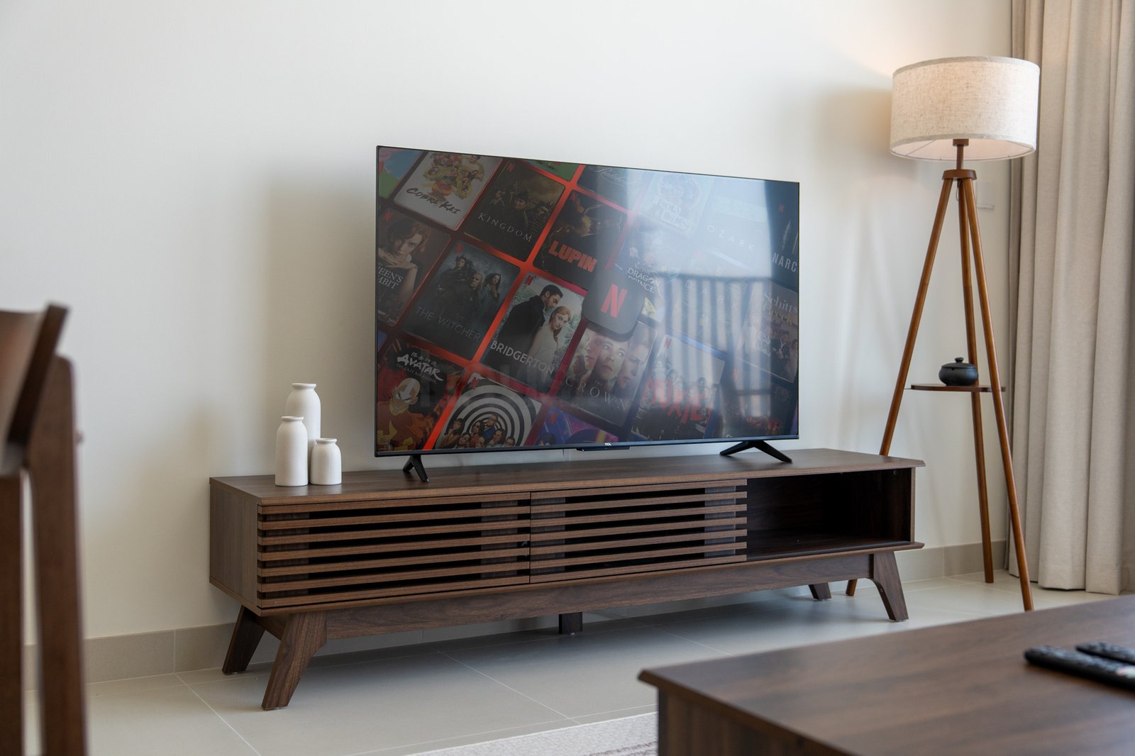 Walnut media unit with smart TV and floor lamp